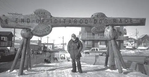 The author stands under the burled arch at the finish line in Nome after - фото 132