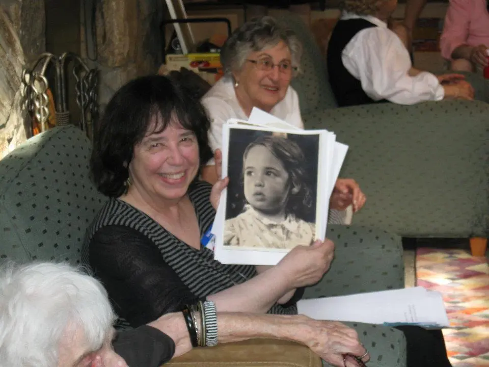 At a Yolen cousins reunion as a child holding up a photograph of myself In - фото 2