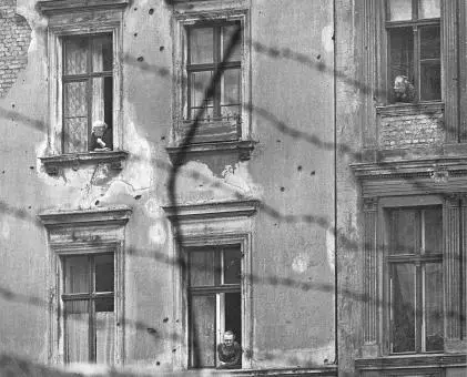 A tale of two cities East Berlin Elderly women look out from apartment - фото 50