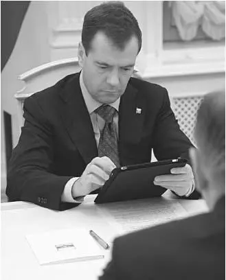The modernising Medvedev is rarely seen without his iPad Courtesy of RIA - фото 34