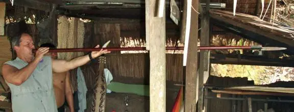 Foster using a Dayak blowgun in Sarawak in northern Borneo Copyright All - фото 11