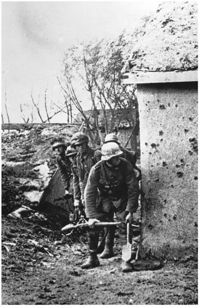 German soldiers crouch behind a bulletpocked wall during fighting in the - фото 59