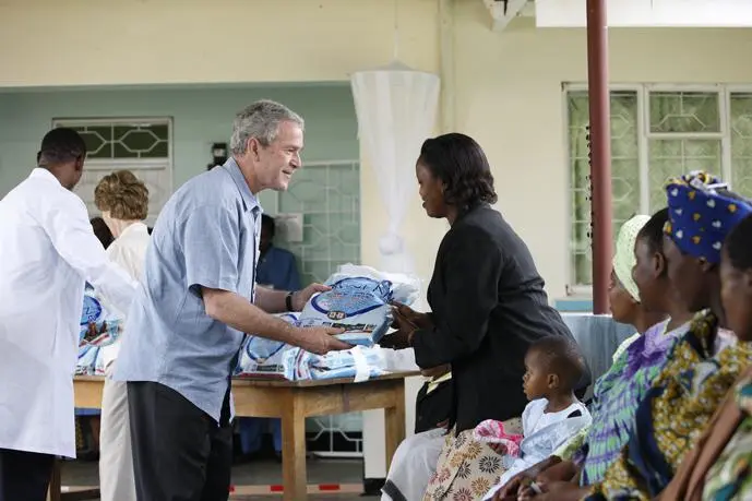Passing out bed nets to mothers in Arusha Tanzania as part of our malaria - фото 346