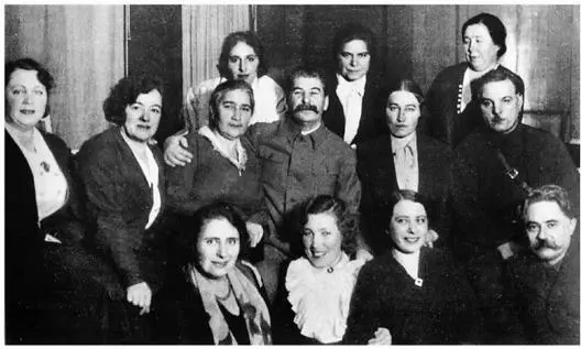 Stalins women his beaming mistress Zhenya Alliluyeva sits at his feet in her - фото 26