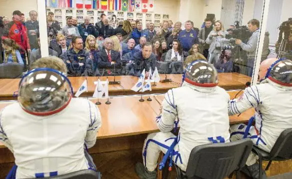 My crewmates and I talk to the media as our families look on from behind a - фото 58