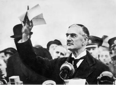 Neville Chamberlain waves the Munich Agreement bearing his and Hitlers - фото 17