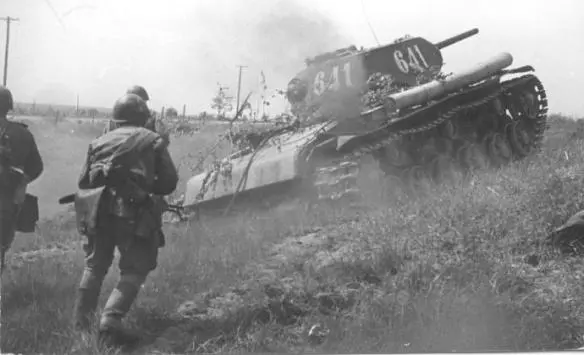 A KV1 heavy tank mounts a slight incline Its complement of tank riders follow - фото 74