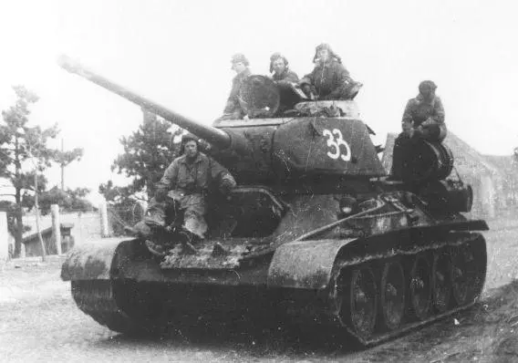 Tank Riders on a column of T3485 tanks move through the streets of a European - фото 75