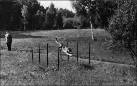 Hitler exercises his Alsatian Blondi in the open meadow east of the - фото 12