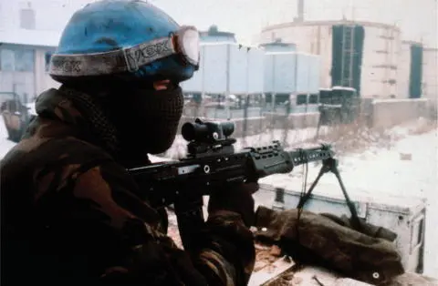 A British soldier keeps watch with an L86A1 LSW from the top hatch of an FV432 - фото 29