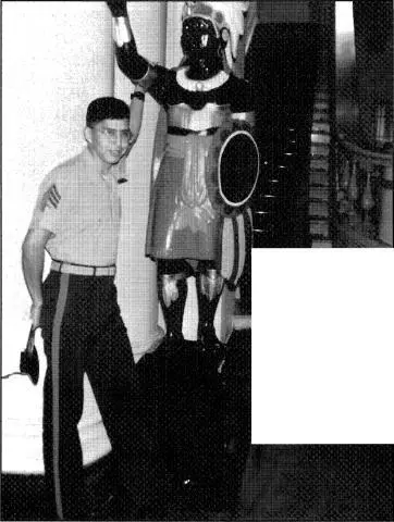3 Sgt Clayton Lonetree standing in front of wooden Indian sculpture at Spaso - фото 4