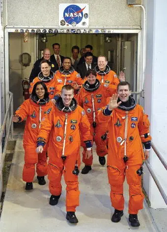 The STS107 crew leaves the Operations and Checkout Building en route to the - фото 32