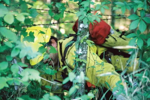 A searcher ducks under a barbed wire fence near Hemphill Searchers had to go - фото 52