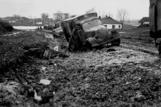 Soldiers try to pull a truck that has slid off the road Ukraine 1944 The road - фото 29
