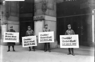 Nazi Stormtroopers hold placards that state Germans defend yourselves Dont - фото 3