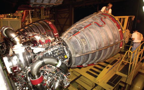 Workers inspect Columbia s 2 main engine before the STS107 mission The - фото 57