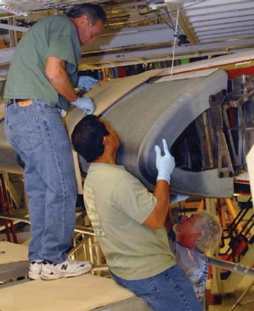 Technicians install a reinforced carboncarbon leading edge panel on an - фото 80